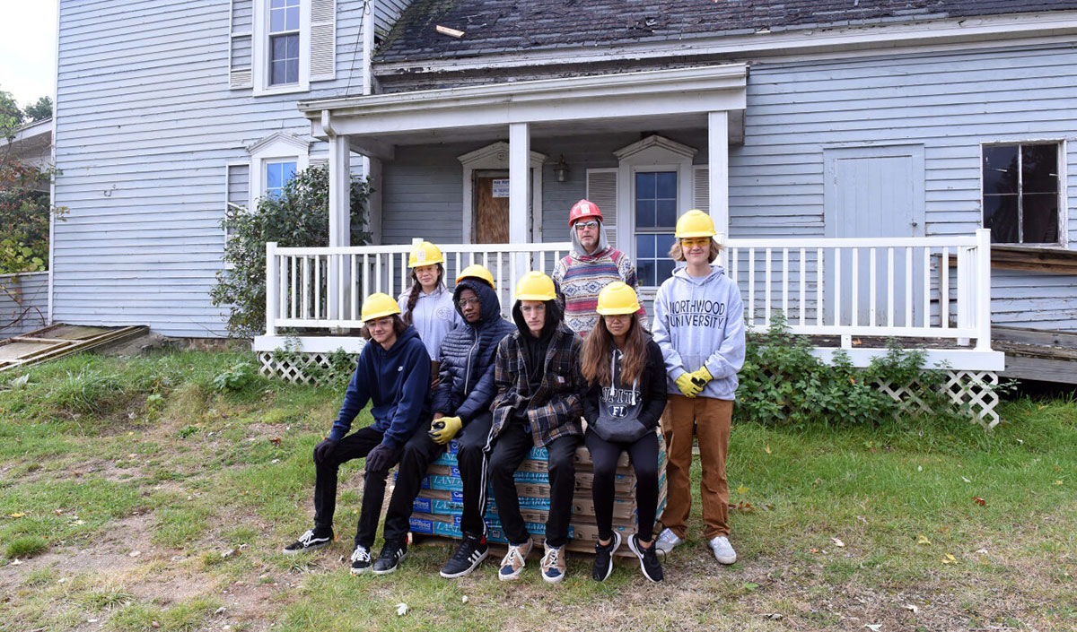 Clarkston Schools Construction Technology Program volunteers help to preserve the Bailey House.