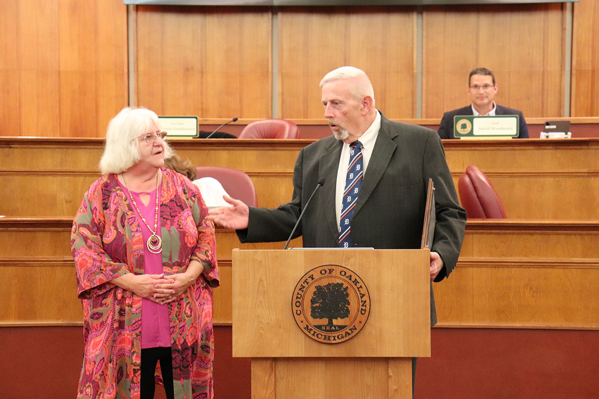 Commissioner Gary R. McGillivray presents a proclamation to Oakland County historian Carol Egbo