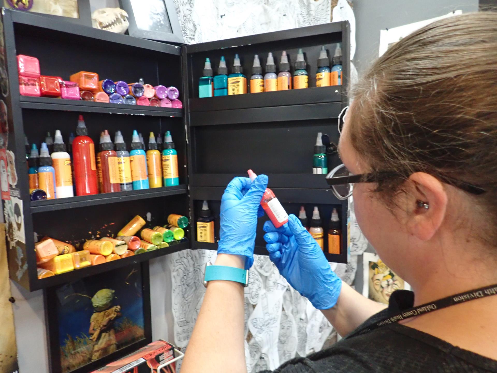 Public Health Sanitarian inspecting a tattoo parlor's inks.