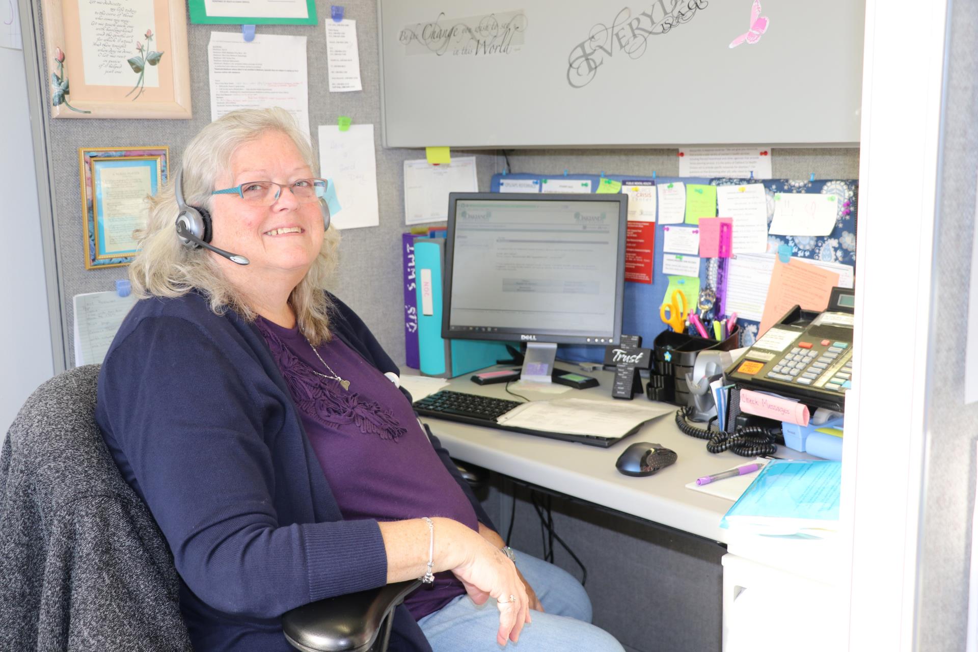 Nurse answering phone calls at a desk.