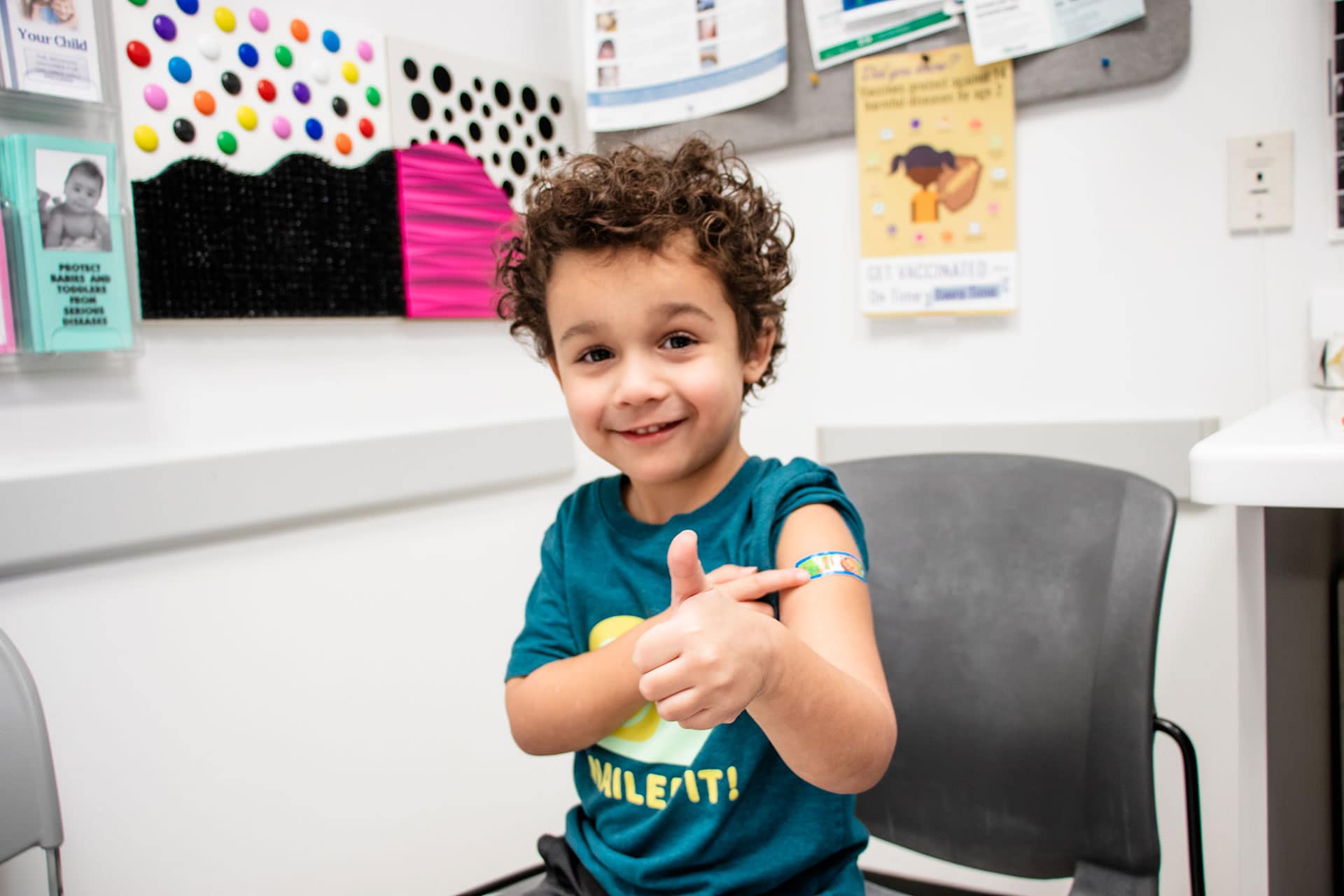 A child with a Band-Aid on their arm that just received a vaccine.