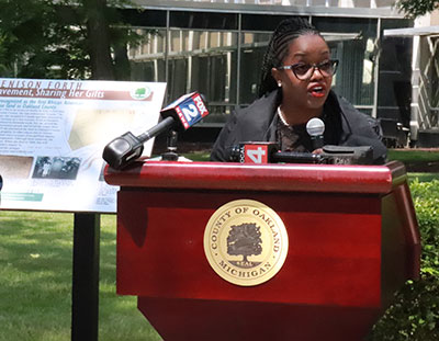 Commissioner Powell speaks at the dedication of a plaque honoring Elizabeth Denison Forth in June 2023.  