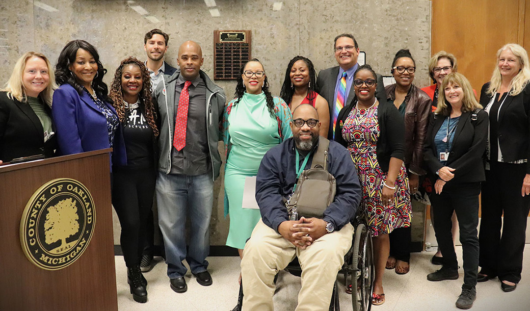 Commissioners, award recipients and county officials unveil the Black Excellence Award plaque