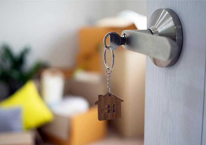 A house key hangs from a door handle, inviting you to open the door and explore what