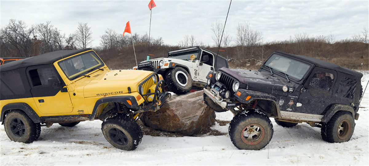 Holly Oaks 3 jeeps parked on a rock.