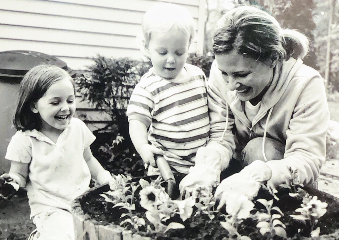 Karen McDonald gardening with two of her children