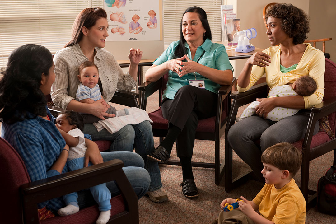 Women and babies sitting in a breastfeeding clinic