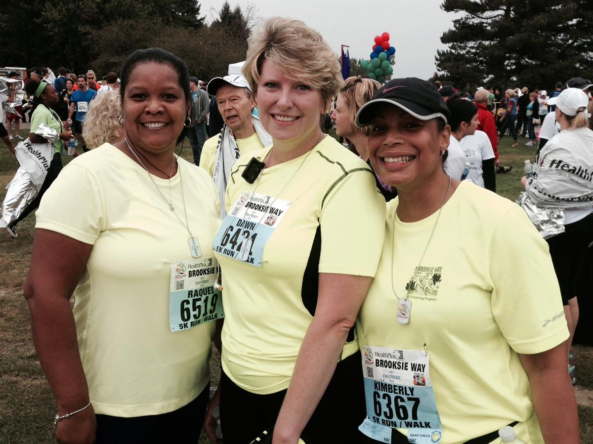 Three people posing for a picture at the Brooksie Way Race.