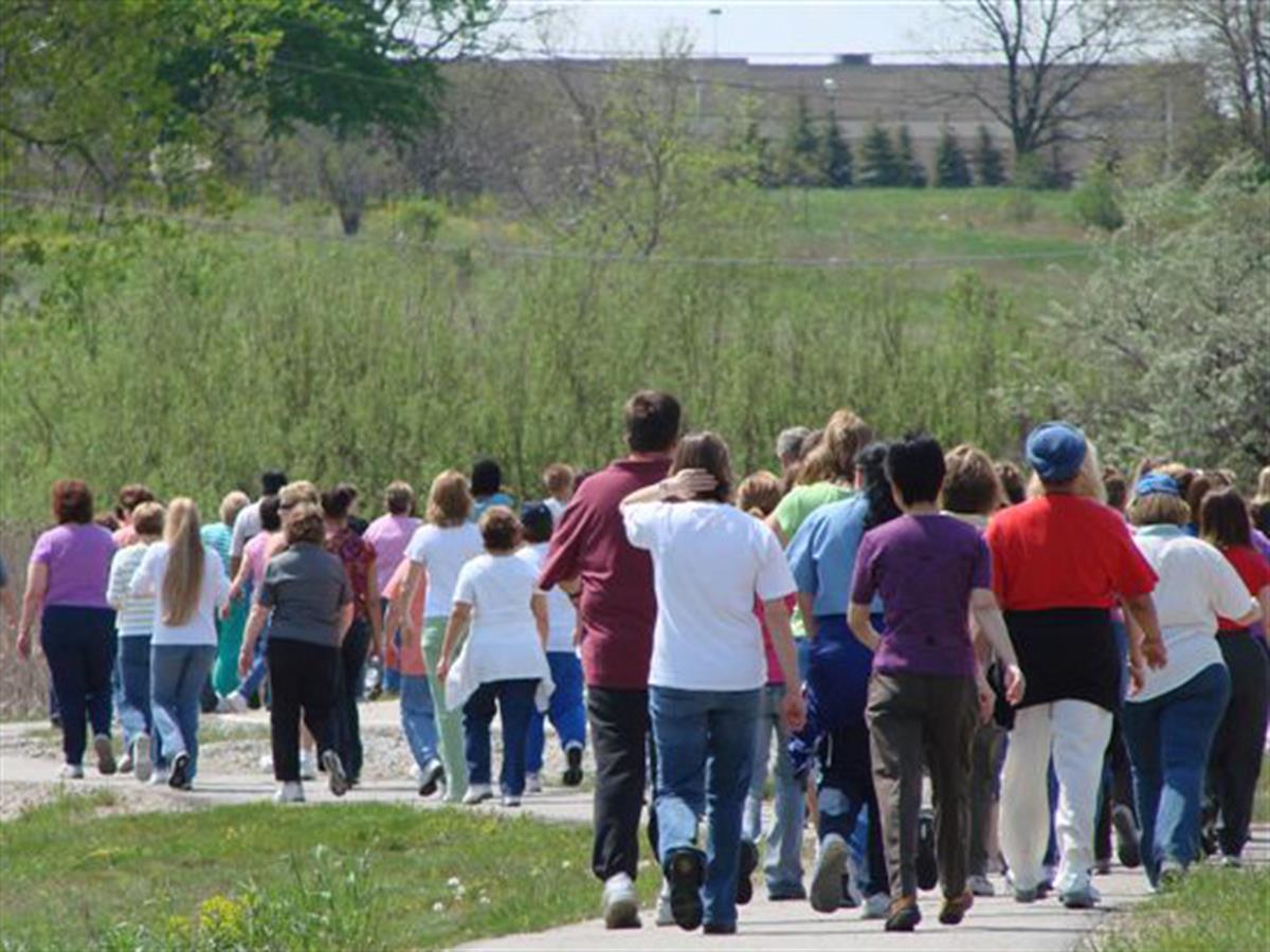 Crowd of people walking away.