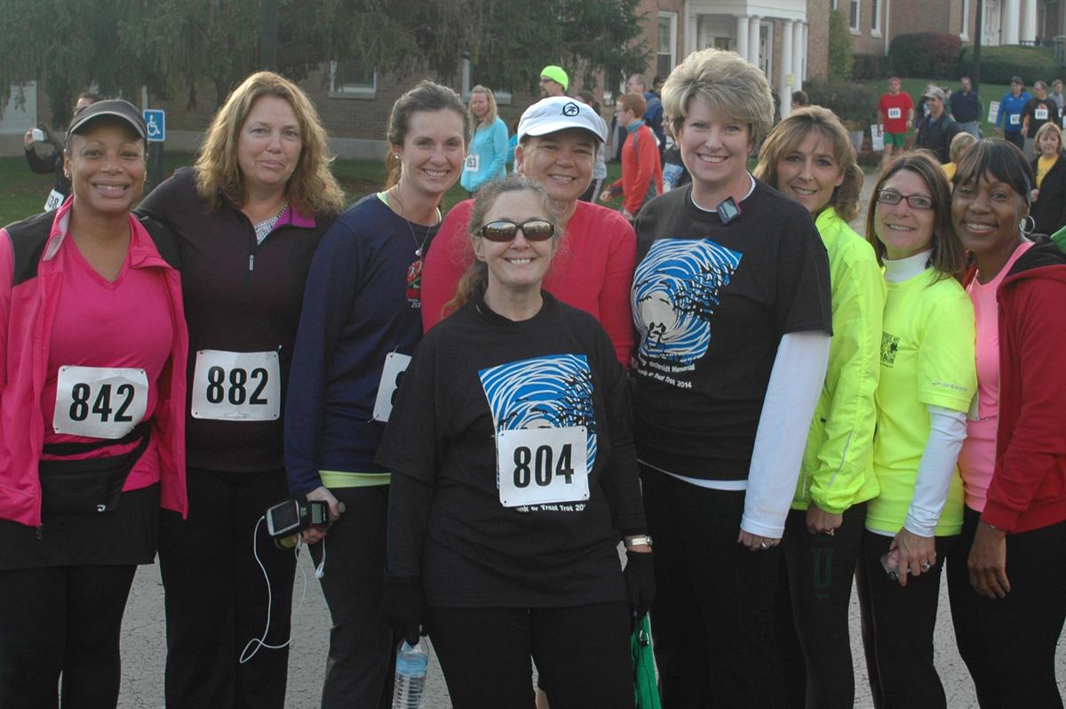 Group of people posing for a picture at a race.