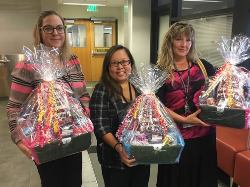 Group picture holding gift baskets