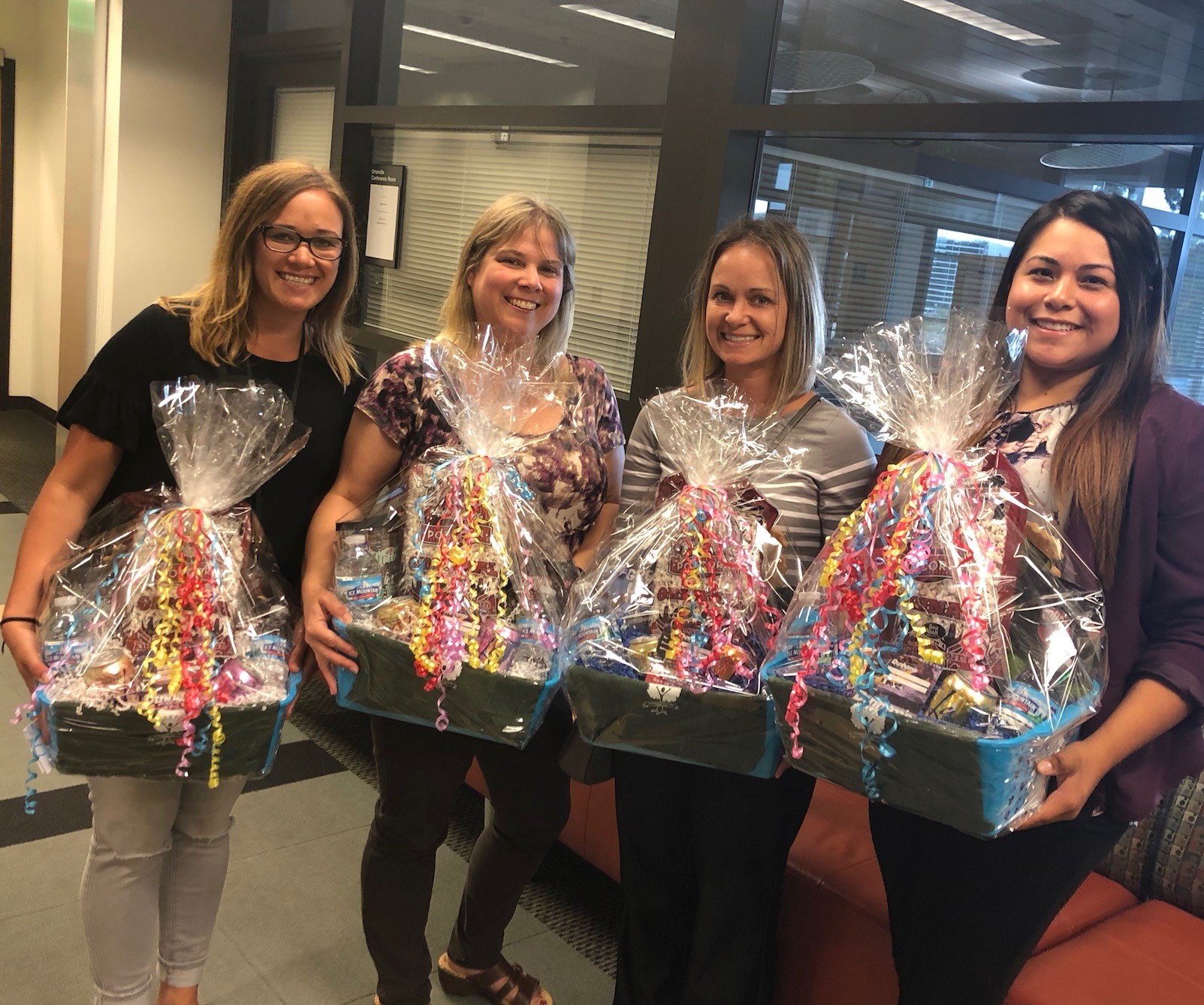 Group picture holding gift baskets