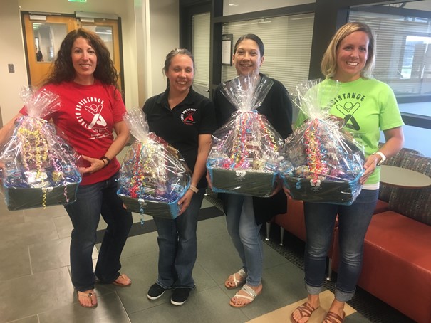 Group picture holding gift baskets