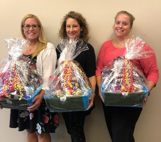 Group picture holding gift baskets