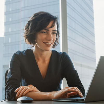 Darlene in office on a computer