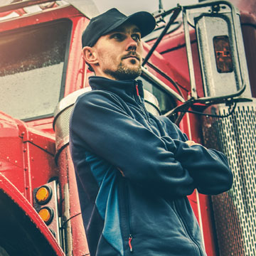 Person leaning against semi truck