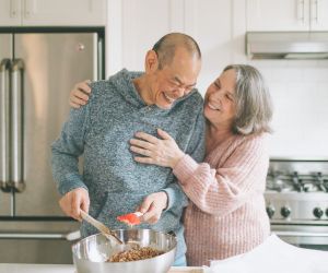 Older adults cooking in a kitchen.